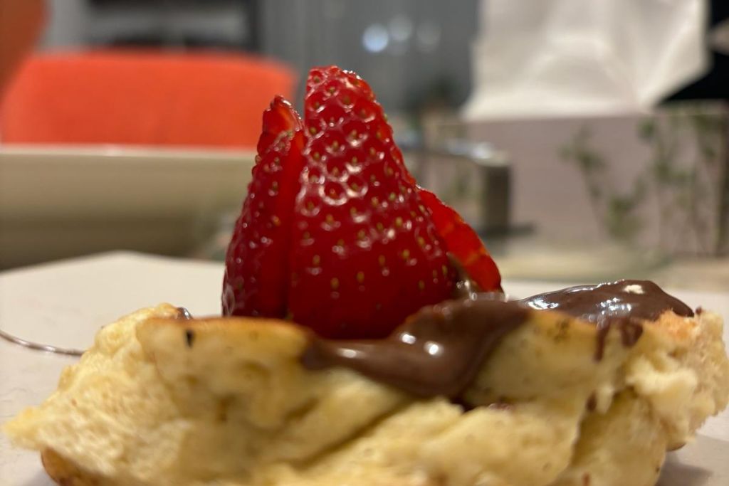 japanese pancake with chocolate and strawberries on a plate