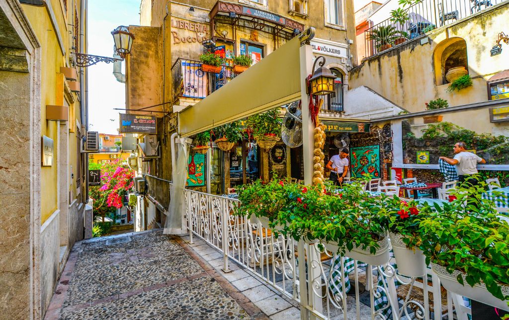 Terrace of a restaurant on a narrow street in Italy