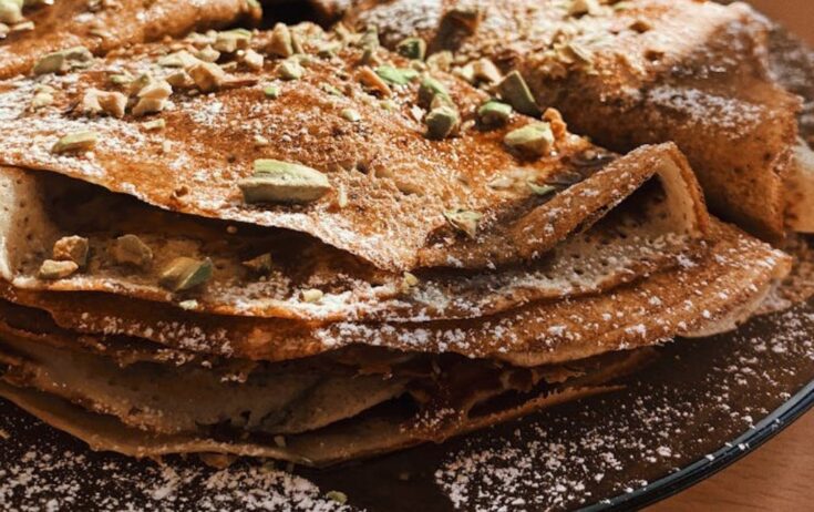 protein pancakes with pumpkin spice and pistachio placed on plate
