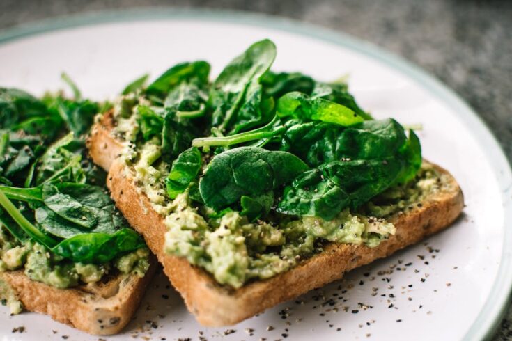 Basil Leaves, Tuna and Avocado on Sliced Bread on White Ceramic Plate