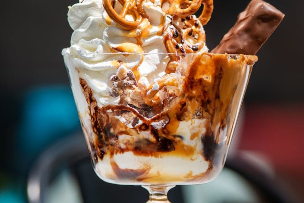 Tasty icea cream pancake decorated with pretzel and ice cream served in a glass