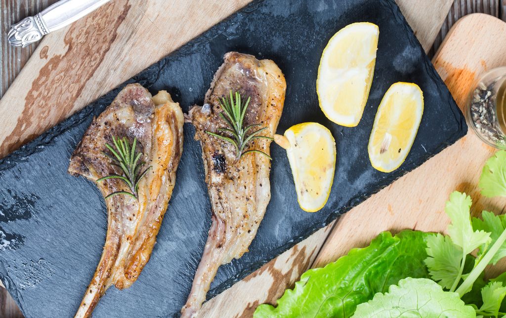 2 cooked t bones with rosmarin near lemon