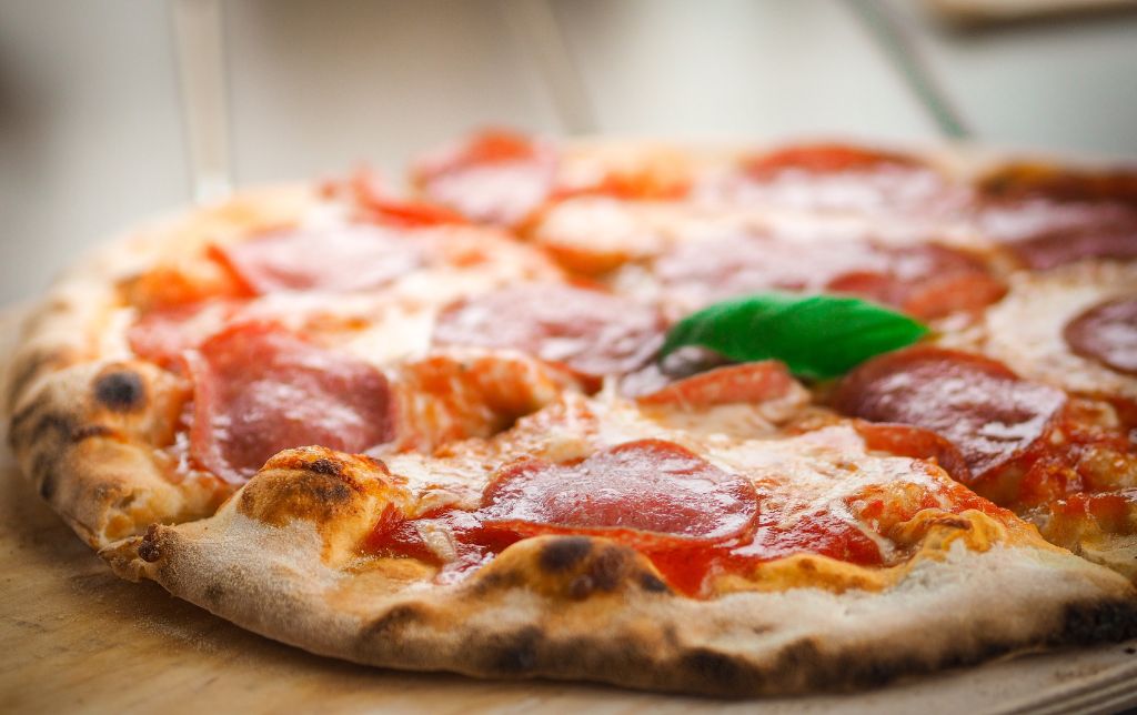 pizza laying on a wooden table