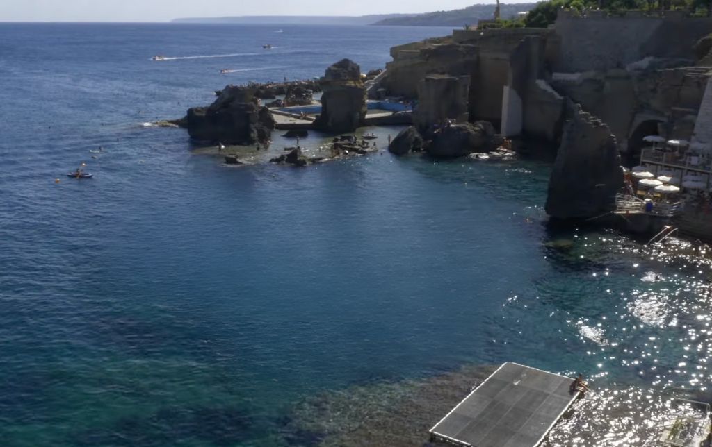 ancient terme ruins in the sea water and a pool in the distance - view from above