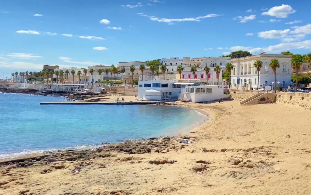 calm small gulf with sandy beach and white small houses