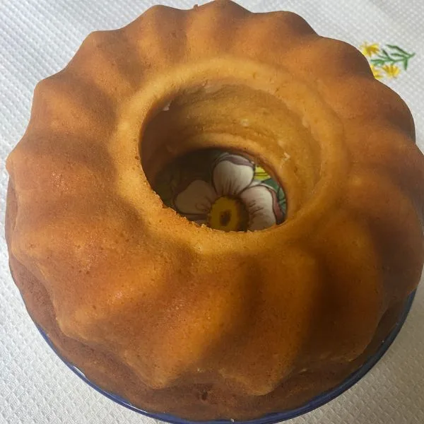 lemonade cake on a plate on a white flowery towel