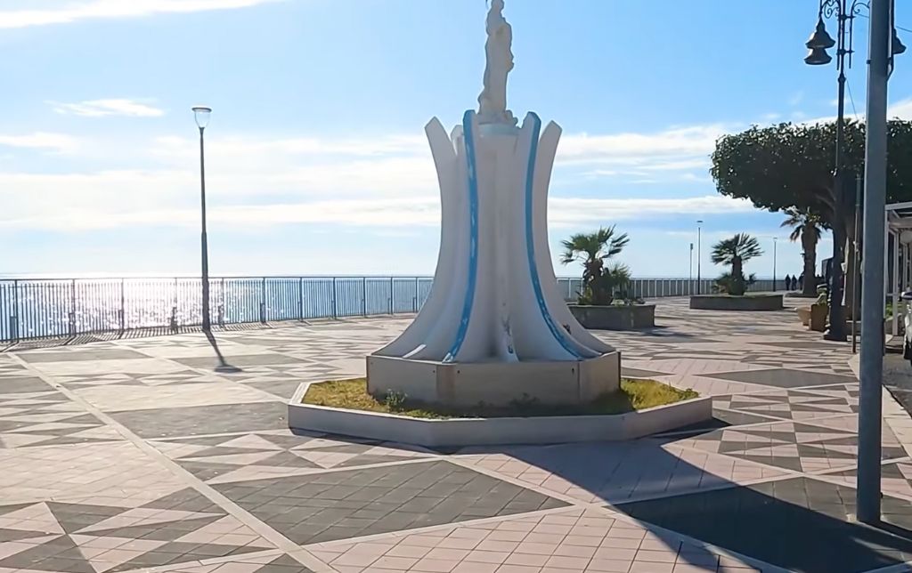 bright piazzetta on the shore with a monument in the middle