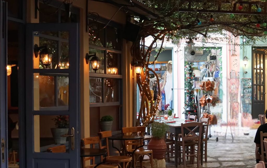 a bar and two shops in the middle of a colourful village