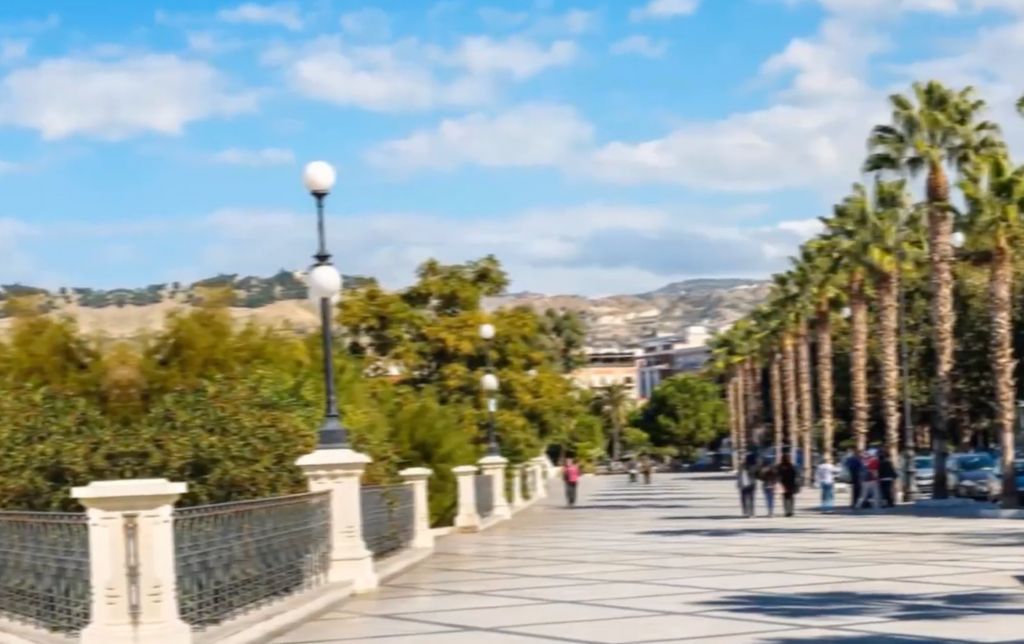 wide walking path along the sea, bamboos blowing in the wind on its right part