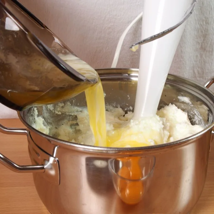 mixing milk and melted butter with dry ingredients for panettone or colomba pasquale