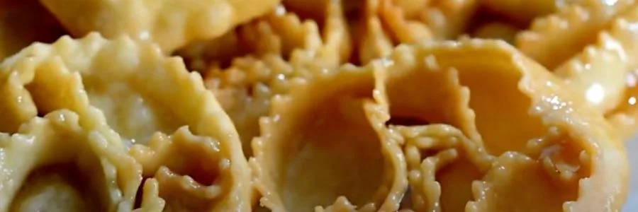 3 cartellate pastries on a white tables