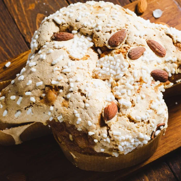 colomba di pasqua dessert lying on a wooden board