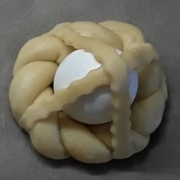 unbaked Cuddura cull'ova on a white table