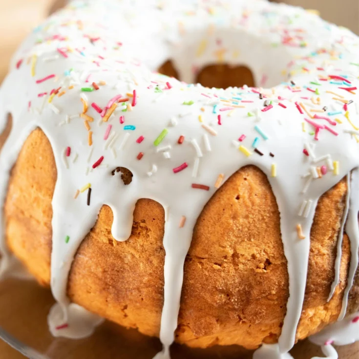 pigna di pasqua glazed with colorful candies, sitting on a wooden table