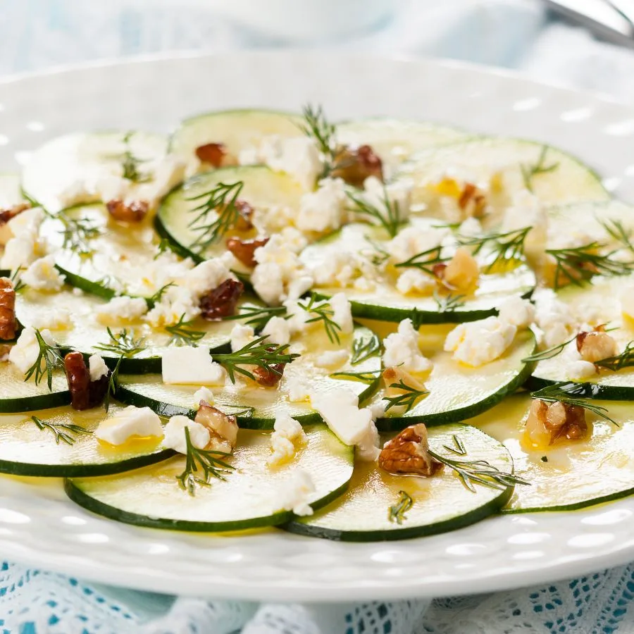 zucchini carpocio with parmezan on a white plate