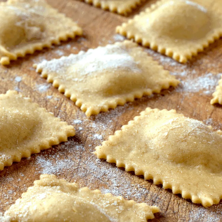 agnolotti cut into squares resting on a wooden table